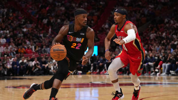 Nov 17, 2021; Miami, Florida, USA; Miami Heat forward Jimmy Butler (22) drives the ball around New Orleans Pelicans guard Devonte' Graham (4) during the second half at FTX Arena. Mandatory Credit: Jasen Vinlove-USA TODAY Sports